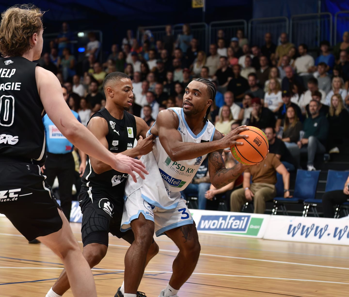 Martel Williams im Zweikampf vor vollen Rängen in der Europahalle